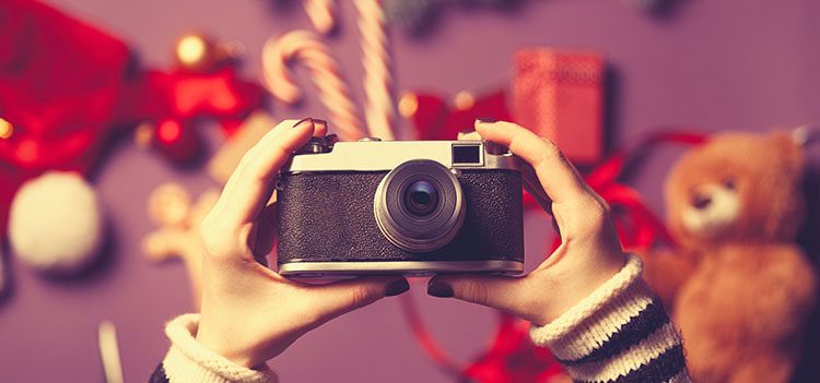 Small vintage camera with Christmas objects in the background