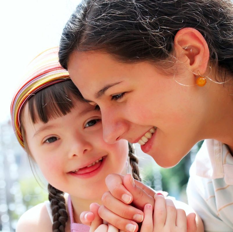 Woman playing and laughing with a girl