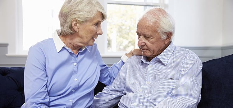 Elderly woman consulting an elderly man