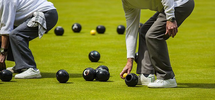 Elderly people playing bowls