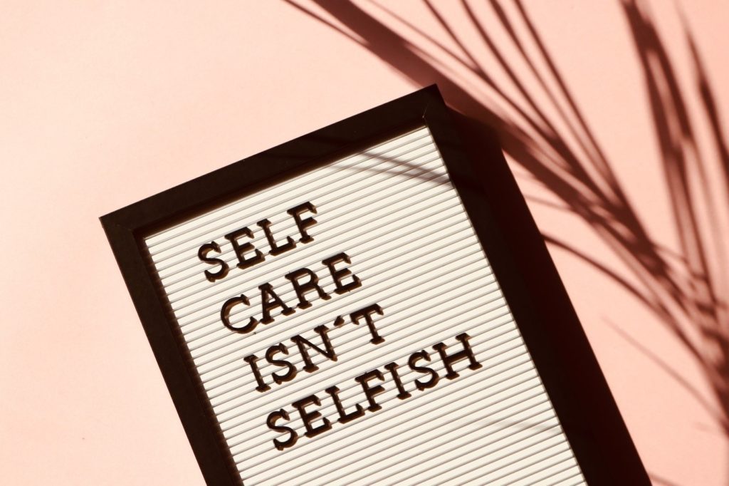black frame with self care isn't selfish written inside it