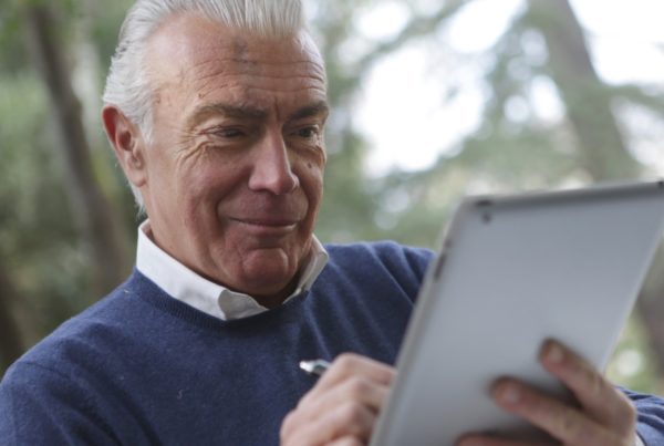 Older gentleman using a computer tablet